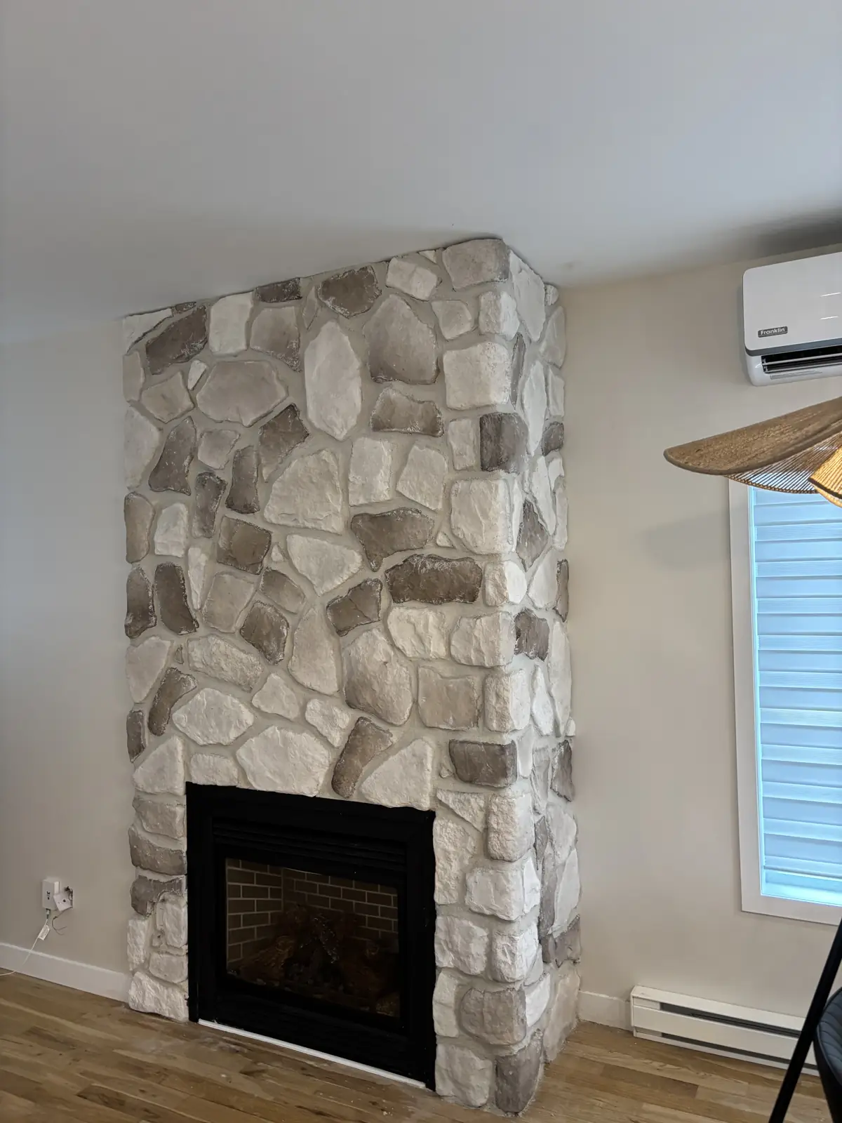Indoor fireplace clad in natural stone